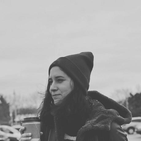 A black and white profile picture displaying a woman sipping on coffee